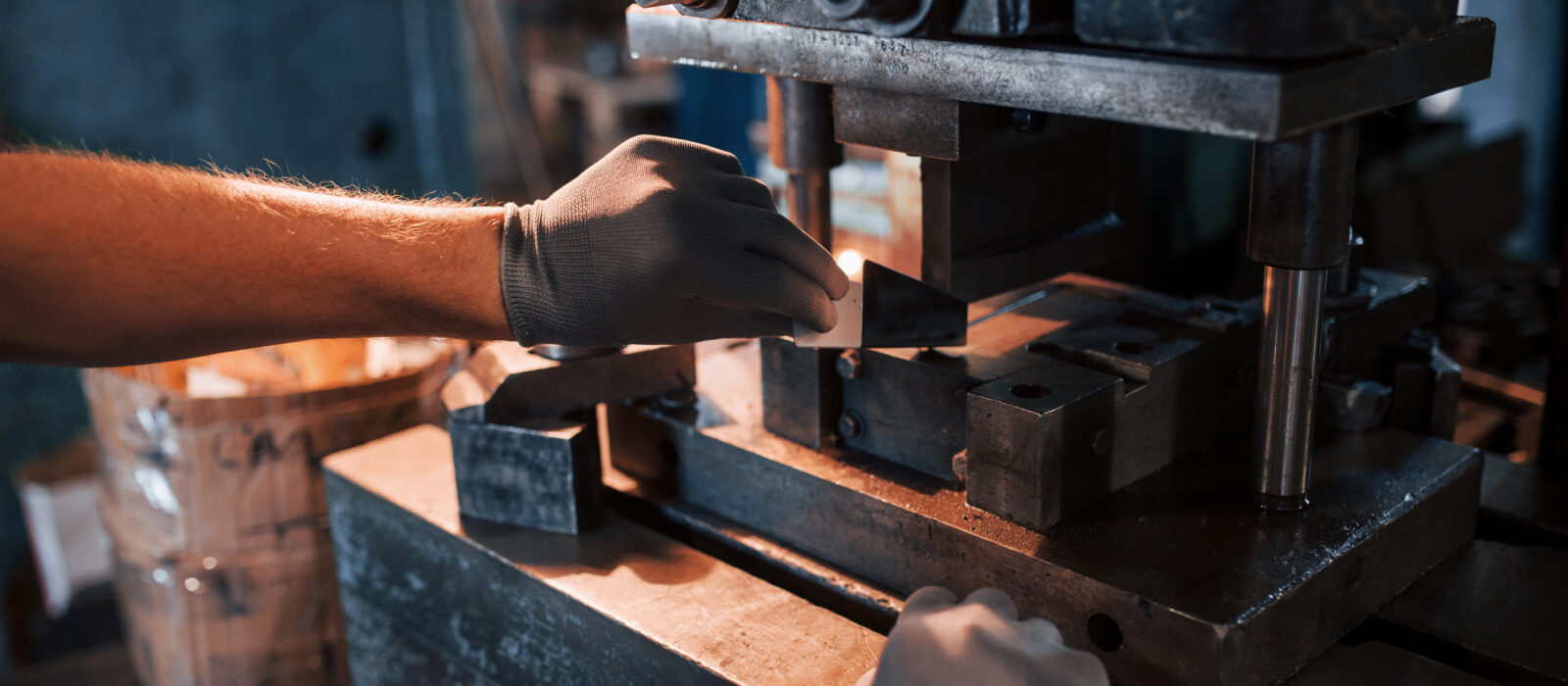 A color photograph of man's hands works with metal. Industrial conception.